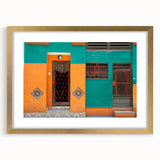 Abstract art print of a Caribbean scene, featuring muted blue and green tones on a framed gold mat.