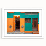Textured abstract art print depicting a Caribbean scene in vibrant blue and green tones, framed with a white mat.