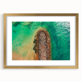 Abstract art print of a Caribbean scenery in muted blue and green tones, framed in gold, suitable for dining room decor.
