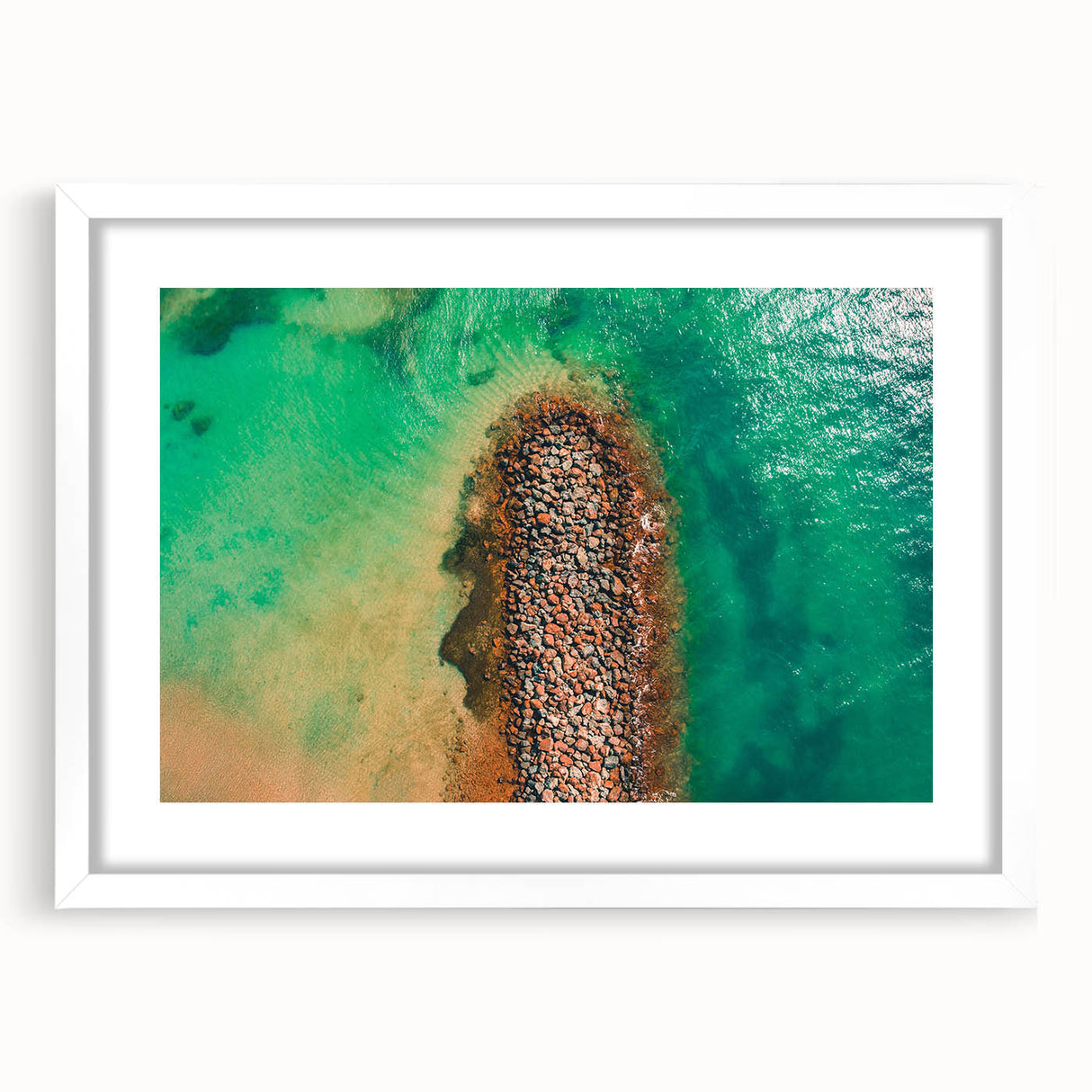 Textured abstract art print of Caribbean scenery in muted blue and green tones, framed with a white mat.
