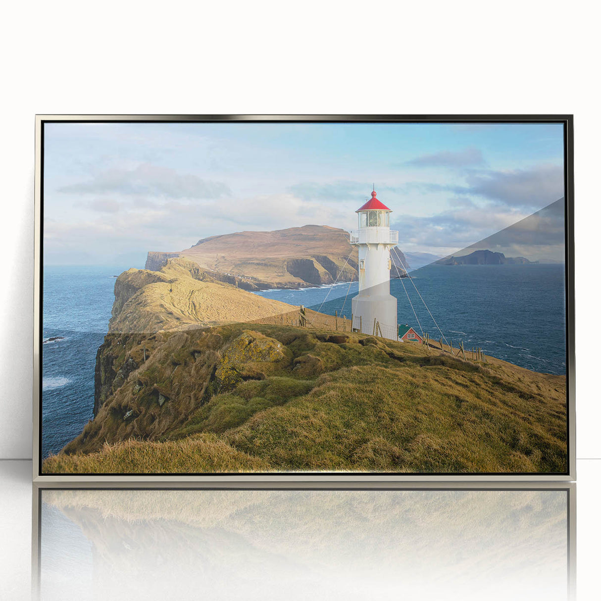 Large art print of a Danish landscape in muted green and blue hues on silver-framed acrylic.