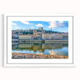 Textured abstract art print of Lyon scenery in muted earth tones on a framed white mat, suitable for bedroom decor.