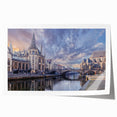 Rolled print of a European scenery with lush floral foreground and a distant village, in soft earth tones.