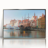 Large art print of a European cityscape in muted gray and blue tones, framed in silver acrylic.