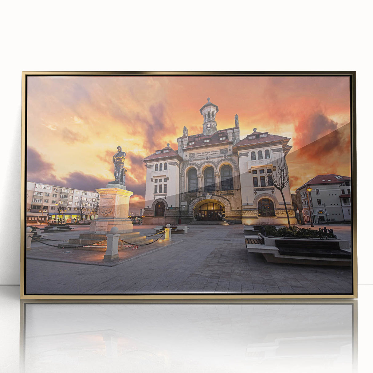 Art deco poster of a Romanian landscape in muted gold and green tones, framed acrylic.