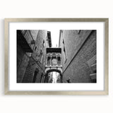 Extra large abstract print of Barcelona scenery in muted earth tones on a silver-framed canvas.