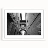 Textured abstract art print depicting a muted color palette of Barcelona scenery, framed in white.