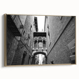 Framed canvas depicting a vintage-style Barcelona landscape in muted gold and black, ideal for bedroom wall art.