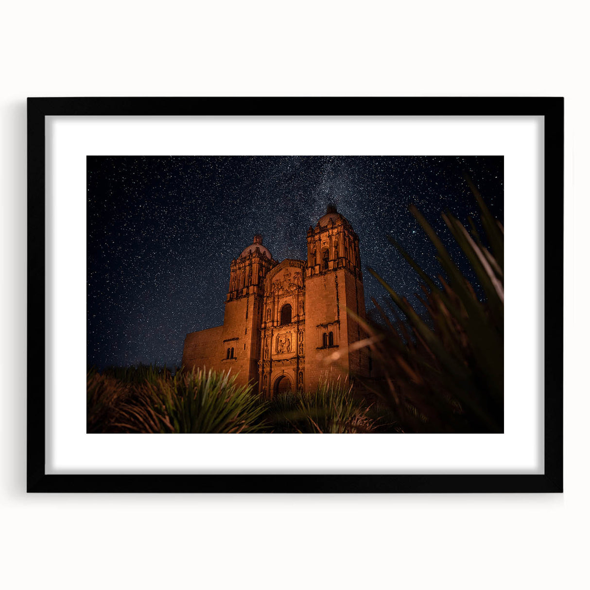Extra large, textured abstract art print depicting colorful, abstract scenery of Oaxaca, framed in black.