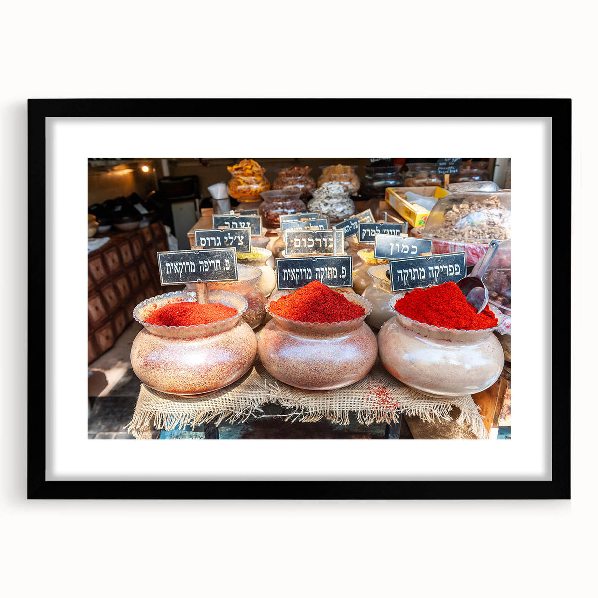 Abstract art print of Tel Aviv with vibrant colors on textured canvas, framed in black, ideal for living room decor.