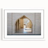 Abstract art print of a Qatar scenery in muted earth tones on a framed white mat, suitable for dining room decor.