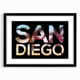 Colorful abstract art print of San Diego scenery in vibrant hues on a large textured canvas, framed in black.