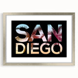 Textured art print of abstract San Diego scenery in muted blues and grays, framed in silver, ideal for bedroom art.