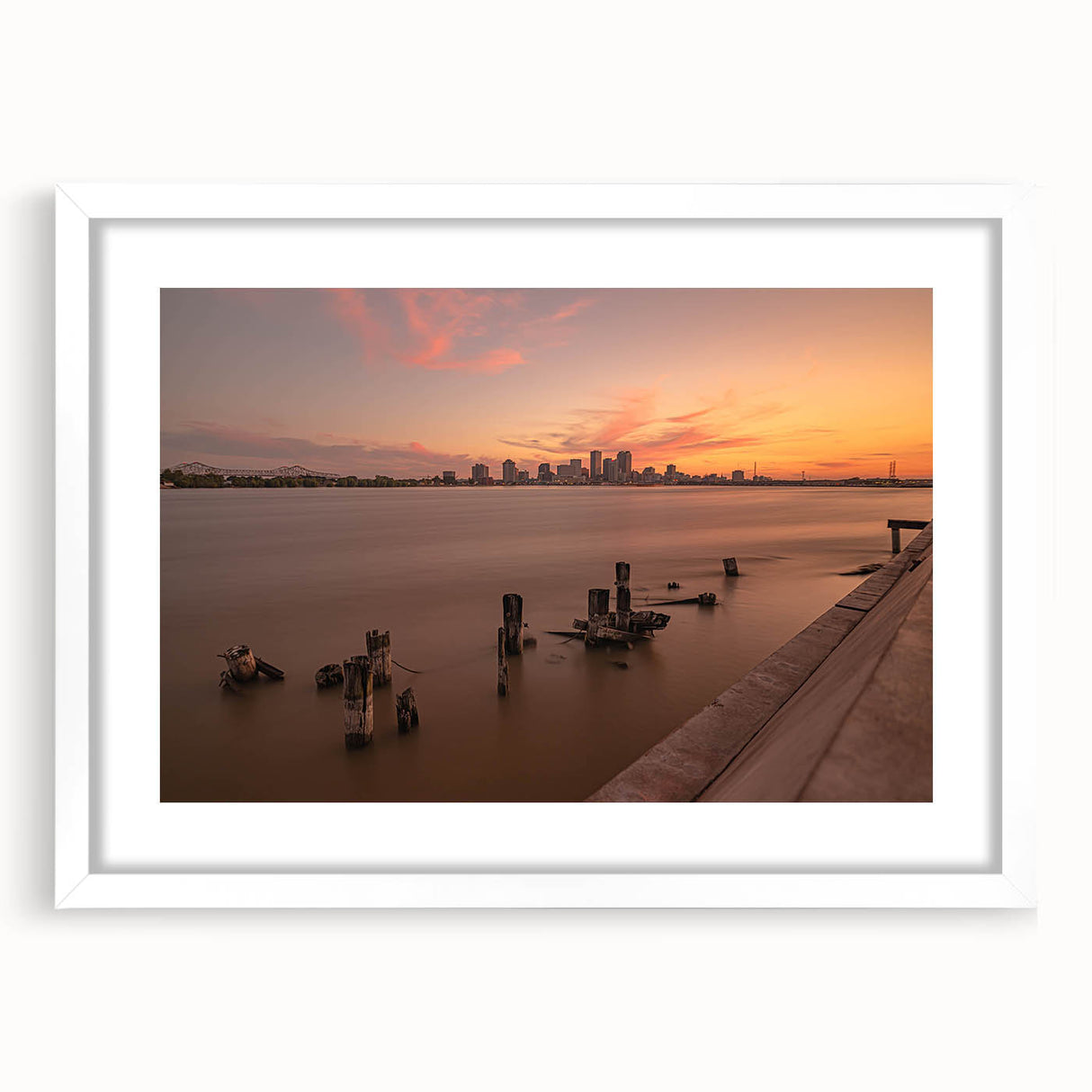 Abstract art print of Louisiana scenery in muted green and blue tones on a framed white mat, ideal for dining room decor.