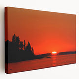 Landscape painting of Maine's coastline on a stretched canvas, featuring muted blue and gray tones.