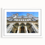 Abstract art print of St. Louis skyline in muted blue and gray tones on a framed white mat, ideal for dining room decor.