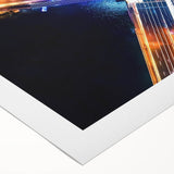 Rolled canvas showcasing a vibrant landscape bridge artwork, featuring rich colors and intricate details, packaged securely in a durable cardboard tube for safe shipping.