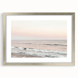 Textured abstract art print in vibrant orange and yellow tones, framed in silver, ideal for bedroom decor.