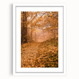Abstract art print featuring autumnal colors in a white frame, suitable for bedroom or dining room decor.