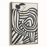 Abstract figurative framed canvas artwork showcasing a gold and black design, elegantly displayed at a side angle, perfect for modern home decor.