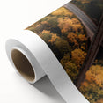Rolled canvas artwork showcasing a vibrant landscape bridge design with rich colors and intricate details, carefully packaged in a durable cardboard tube for safe shipping and display.