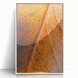 Art deco poster of a stylized autumn tree in warm orange tones, acrylic print in a white frame.