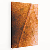 Side view of a large stretched canvas depicting a fall season theme with warm orange and brown tones.