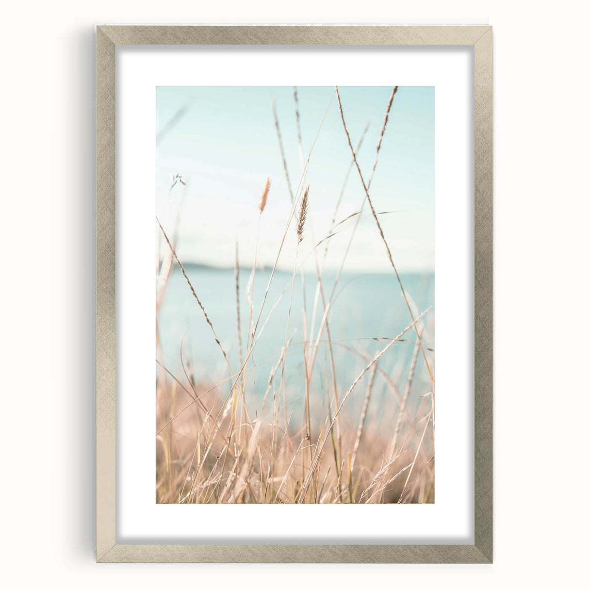 Abstract textured art print in vibrant orange and yellow hues on a silver-framed canvas.