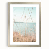 Abstract textured art print in vibrant orange and yellow hues on a silver-framed canvas.