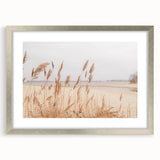 Textured art abstract print with swirls in orange and yellow, framed in silver, suitable for bedroom decor.