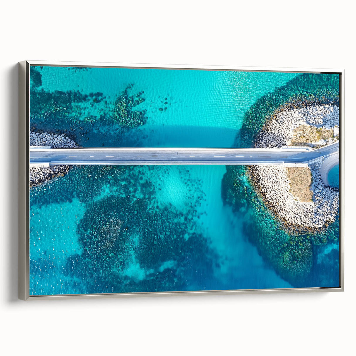 Framed canvas artwork depicting a serene landscape with a bridge, featuring a silver frame. The piece highlights tranquil colors and detailed textures, perfect for home decor.