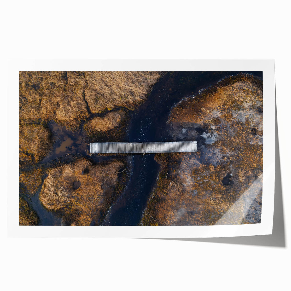 Landscape bridge rolled print showcasing a serene river scene under a vibrant sunset, featuring rich colors and intricate details, packaged in a protective tube for safe delivery.