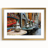 Textured abstract art print depicting a Moroccan scenery in earth tones, framed in gold, suitable for bedroom decor.