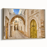 Framed canvas landscape art of a Tunisian scene in muted earth tones, ideal for bedroom wall decor.