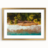 Abstract art print of a Caribbean scenery in muted blue and green tones, framed in gold, suitable for dining room decor.
