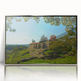 Large art print of a European Albanian scenery in muted earth tones on a silver-framed acrylic.