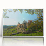 Mid-century modernist art depicting a serene Albanian landscape in muted green and blue tones, framed acrylic.