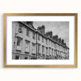 Abstract art print of a European cityscape in gold frame, with muted earth tones, ideal for dining room decor.