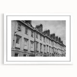 Textured art of a European cityscape in muted earth tones, framed with a white mat, suitable for bedroom decor.