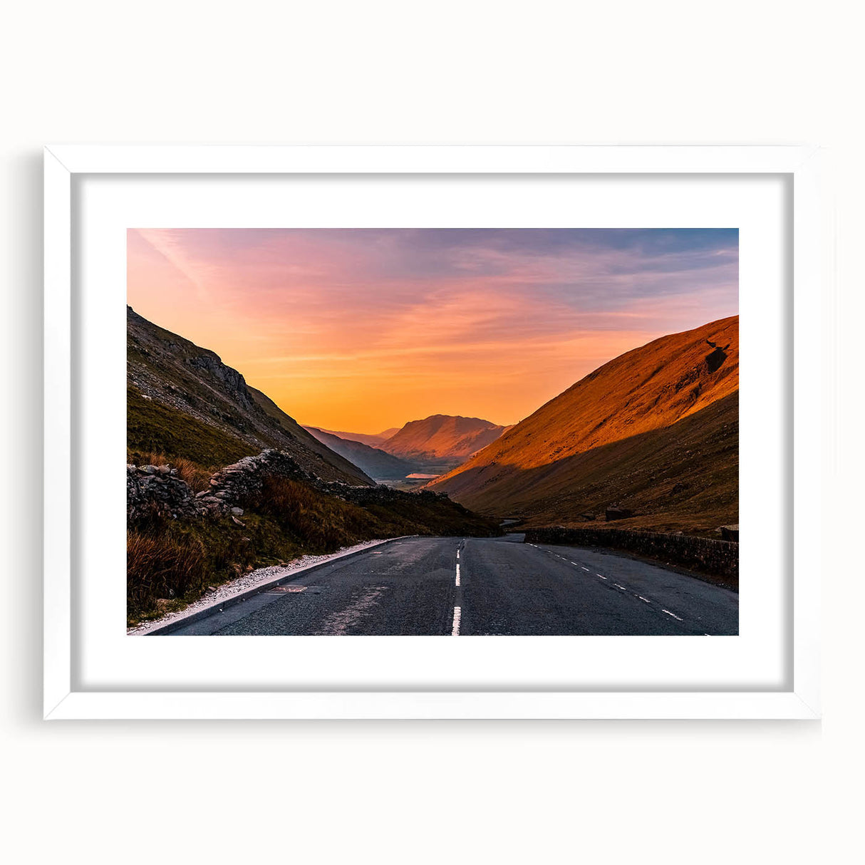 Textured art depicting abstract hills in muted green and blue tones, framed with a white mat, suitable for bedroom decor.