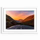 Textured art depicting abstract hills in muted green and blue tones, framed with a white mat, suitable for bedroom decor.