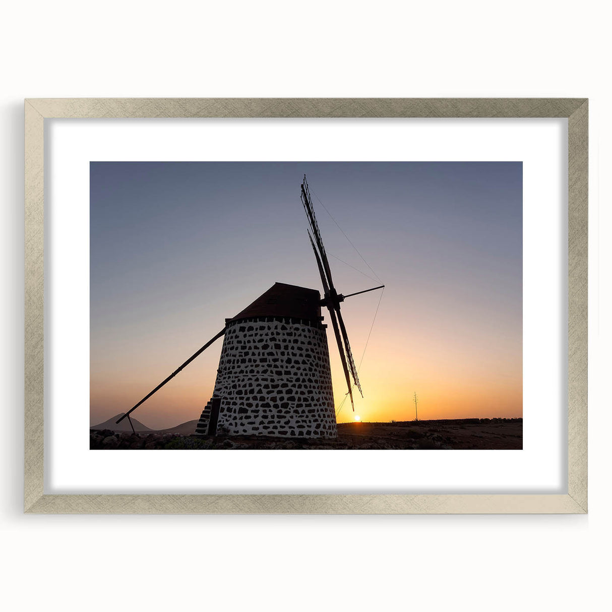 Extra large abstract art print of a textured European scenery in muted earth tones, framed with a silver mat.