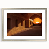 Textured art print depicting an abstract Middle Eastern scenery in muted earth tones on a framed canvas.