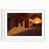 Abstract art print featuring a stylized Middle Eastern landscape in muted earth tones on a framed white mat.