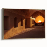 Framed canvas featuring a vintage-style landscape painting of a Middle Eastern scene in muted gold and black tones.