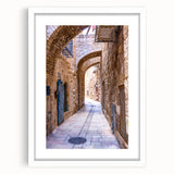 Abstract art print of Tel Aviv skyline in muted gray and blue tones on a framed white mat, suitable for dining room decor.