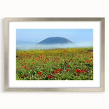 Textured abstract art print of a Middle Eastern scenery in muted earth tones on a silver-framed canvas.