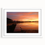 Abstract art print of an Alabama landscape in muted green and blue tones on a framed white mat, ideal for dining room decor.