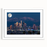 Abstract art print of Los Angeles skyline in muted blue and gray tones on a framed white mat, ideal for dining room decor.