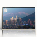 Mid-century modernist art depicting Los Angeles skyline in muted colors on a silver-framed acrylic.